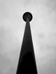 Minimalist Low-Angle Streetlight Pole Against Grey Sky